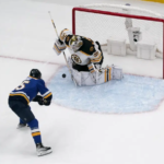 Bruins reach win number 60 after Blues shootout